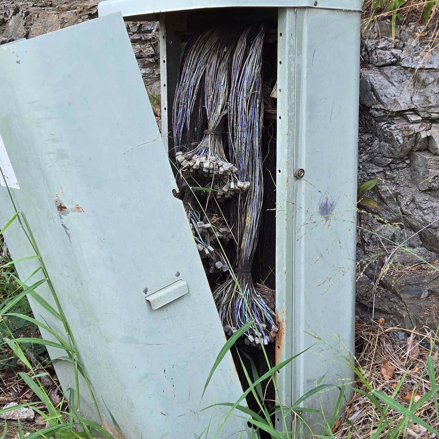 Open electrical cabinet with exposed wires