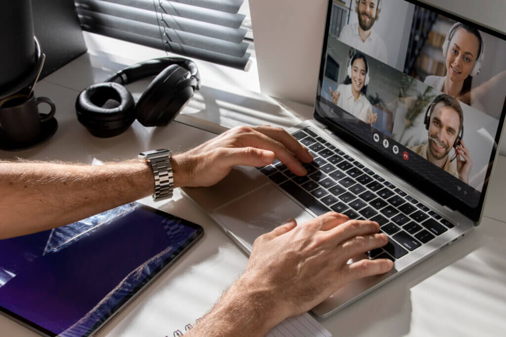 Person attending remote meeting on laptop.