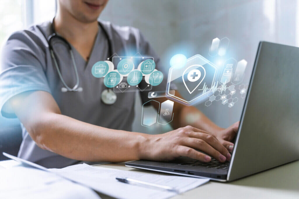 Healthcare professional using digital platform on laptop.